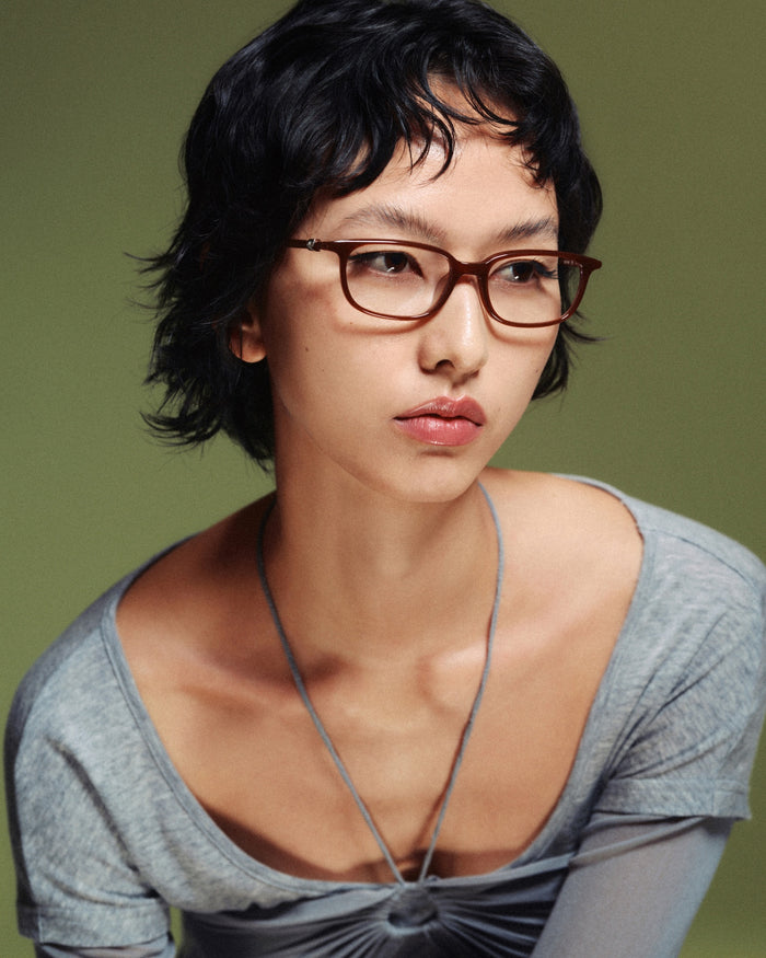 Side shot of Bonnie Clyde Rookie optical frames in brown with clear lenses.