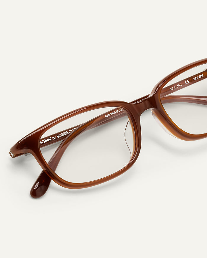 Detail shot of Bonnie Clyde Rookie optical frames in brown with clear lenses.