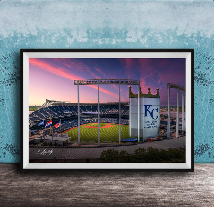 A framed photograph of a baseball stadium at sunset, with the Kansas City Royals logo prominently displayed.