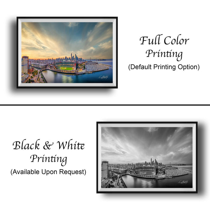 The image is a collage of two framed cityscape photographs. The top photograph is a full color print, while the bottom photograph is a black and white print. Both images depict a city skyline with tall buildings and a body of water in the foreground. The top photograph is labeled "Full Color Printing (Default Printing Option)" and the bottom photograph is labeled "Black & White Printing (Available Upon Request)" to indicate the printing options available for the image.