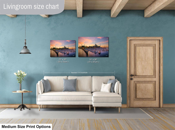 a living room with a white sofa, a wooden door, and a painting of a cityscape on the wall. The painting is of a medium size, and the living room appears to be designed for a comfortable and relaxing atmosphere.