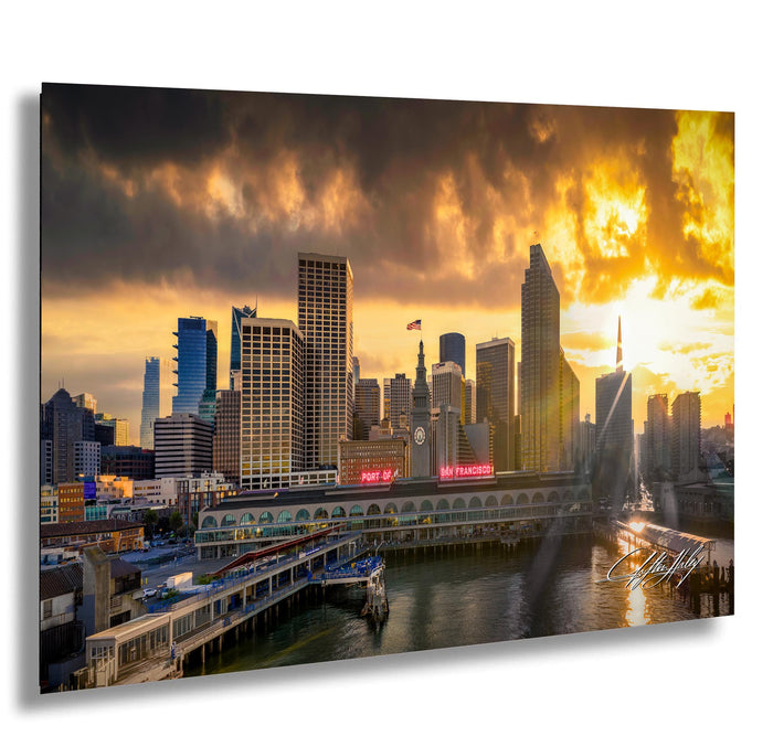 a city skyline at sunset, with tall buildings and a body of water in the foreground.