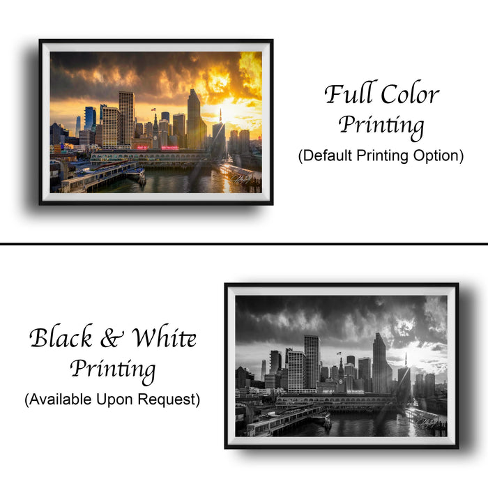 The image is a collage of two framed cityscape photographs. The top photograph is a full color print, while the bottom photograph is a black and white print. Both images depict a city skyline at sunset, with the city's buildings and bridges illuminated by the warm, golden light of the setting sun.