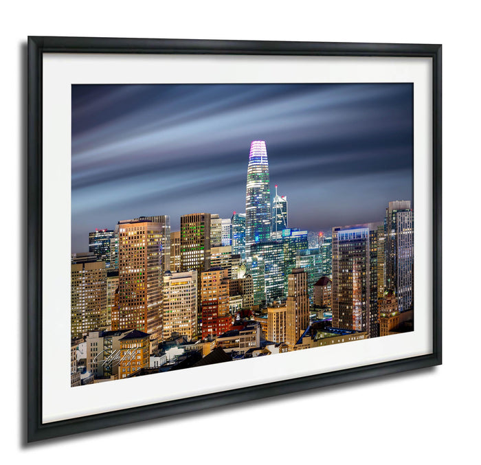 a cityscape at night, with a variety of illuminated skyscrapers and buildings against a dark sky.