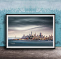 A framed photograph of the San Francisco skyline at sunset, with the Golden Gate Bridge and other iconic structures visible in the distance.