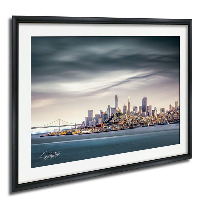 a cityscape with a skyline of tall buildings and a bridge in the background, set against a cloudy sky.