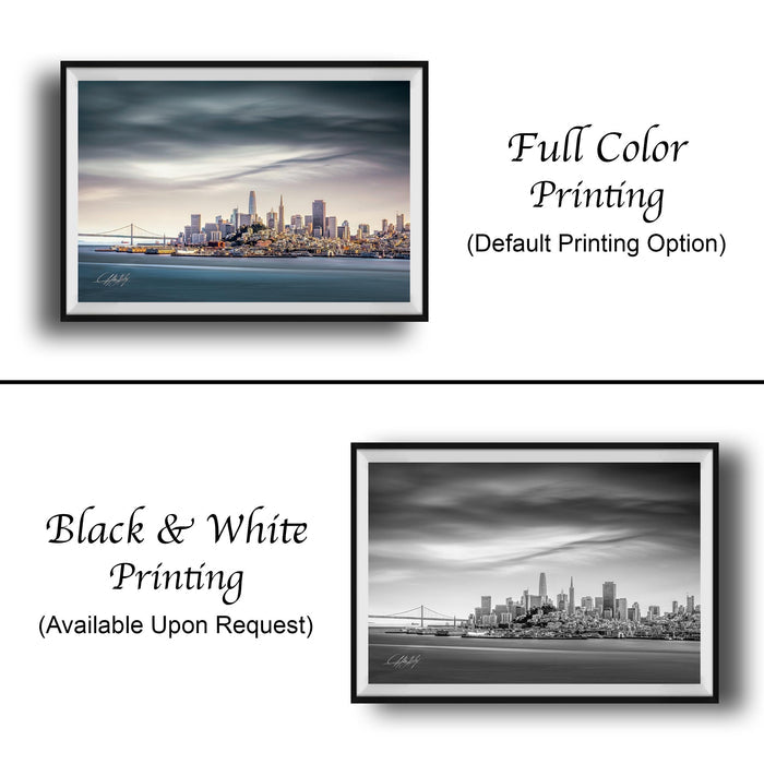 The image is a collage of two framed cityscape photographs. The top photograph is a full-color print, while the bottom photograph is a black and white print. Both images depict a city skyline, with the top photograph in full color and the bottom photograph in black and white. The text below the images indicates that the full-color print is available upon request.