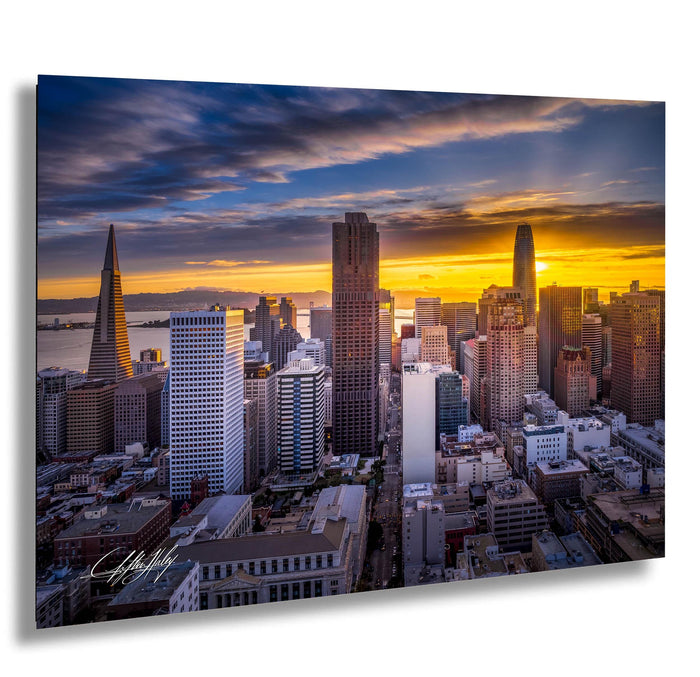 a stunning cityscape at sunset, with a vibrant display of colors in the sky and silhouettes of tall buildings against the backdrop.