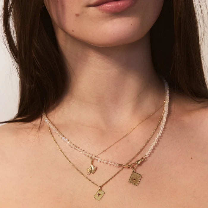 Saskatoon Postcard Charm in 10k yellow gold with ruby, alternate angle detail view
