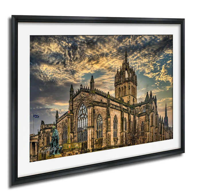 a large, ornate stone church with a tall spire, set against a dramatic sky with clouds.