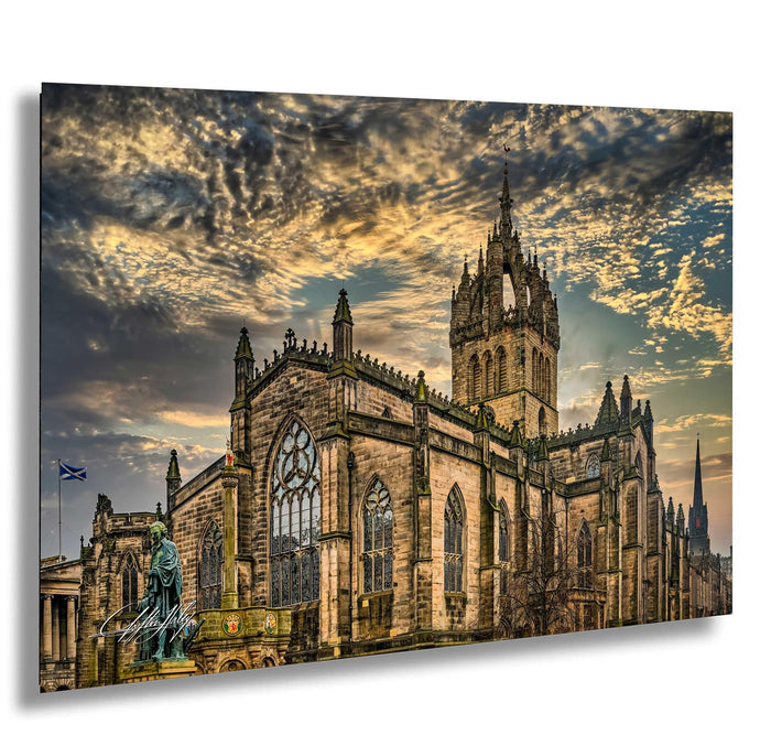 a large, ornate stone church with a tall tower, set against a dramatic sky with clouds.