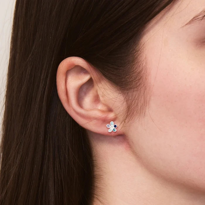 Seaside Forget-me-not Blue Studs in sterling silver, shown worn on hand