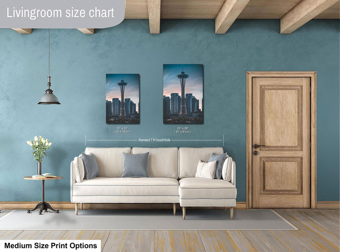 a living room with a white sofa, a wooden door, and a framed picture of the Space Needle on the wall.