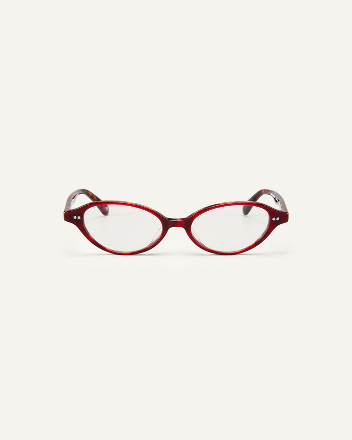 Face shot of Bonnie Clyde Small Talk optical frames in red tortoise with clear lenses.