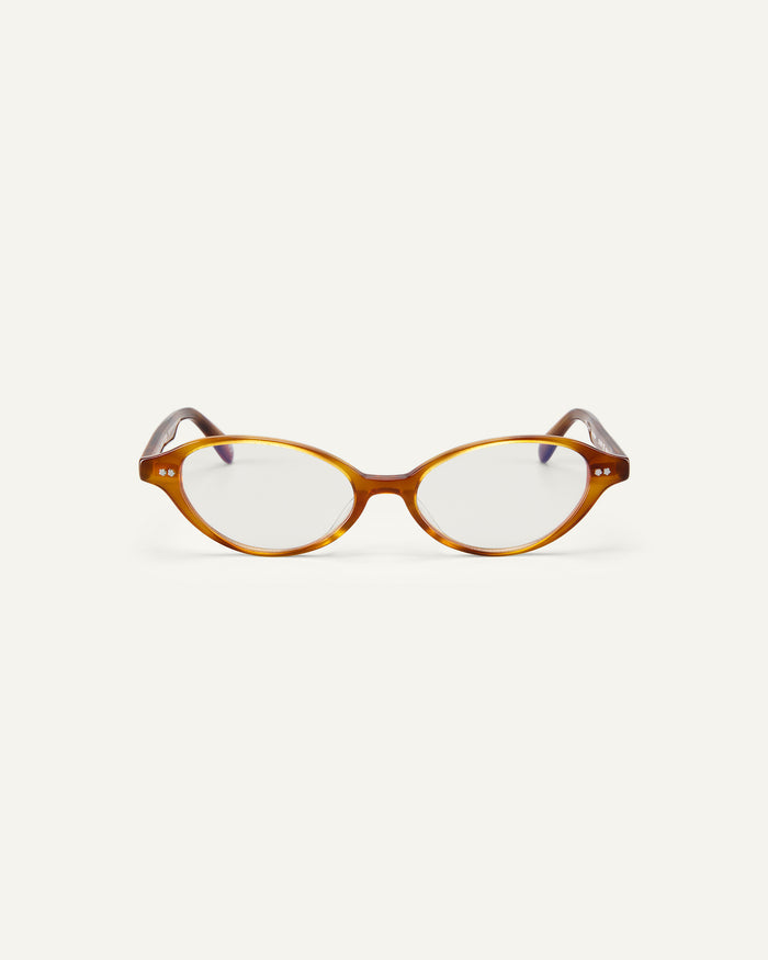 Face shot of Bonnie Clyde Small Talk optical frames in yellow tortoise with clear lenses.