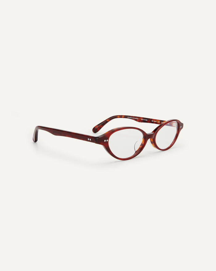 Quarter shot of Bonnie Clyde Small Talk optical frames in red tortoise with clear lenses.