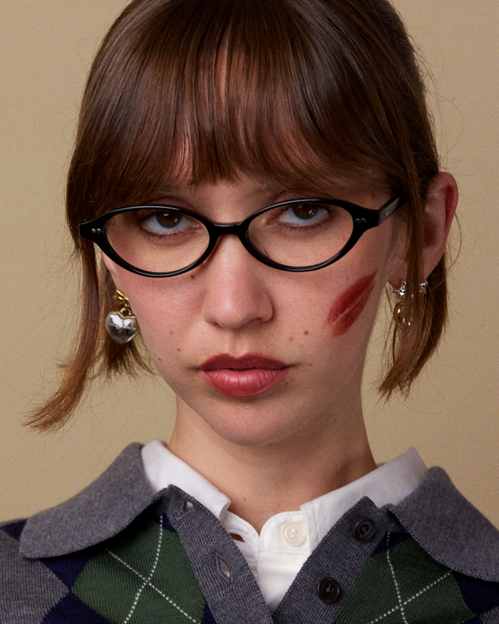 Quarter shot of Bonnie Clyde Small Talk optical frames in black with clear lenses.