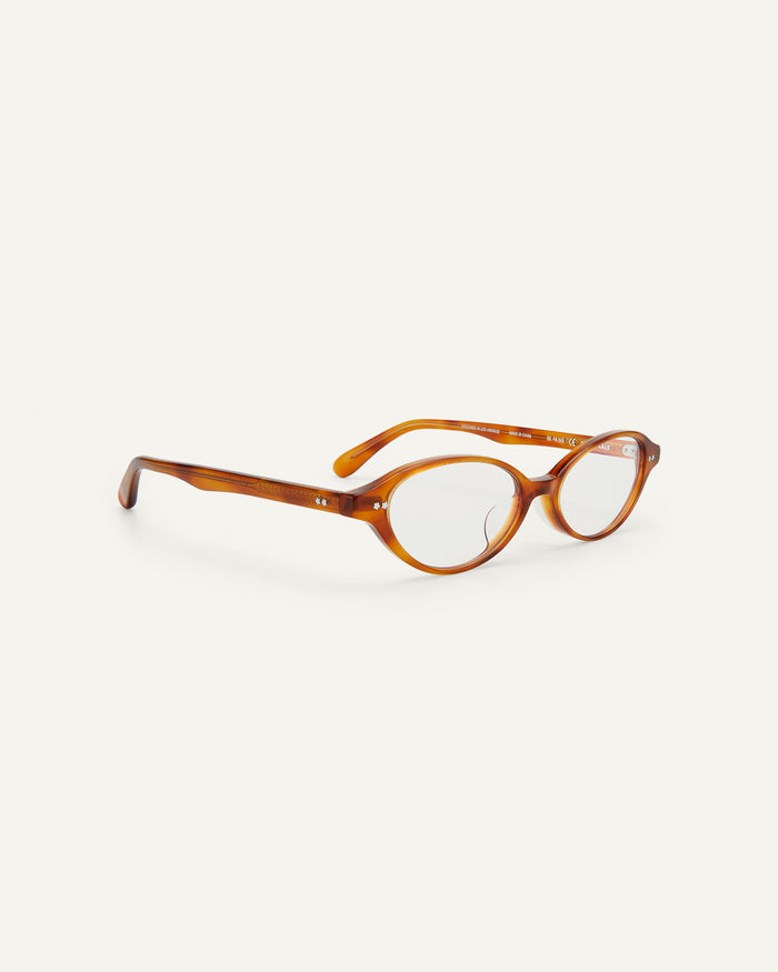 Quarter shot of Bonnie Clyde Small Talk optical frames in yellow tortoise with clear lenses.