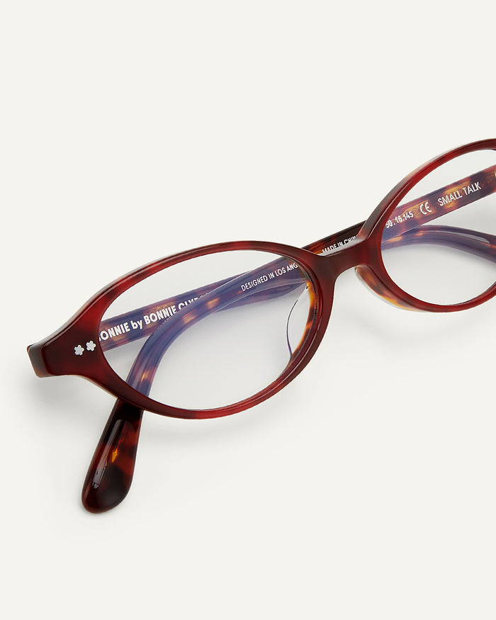Side shot of Bonnie Clyde Small Talk optical frames in red tortoise with clear lenses.