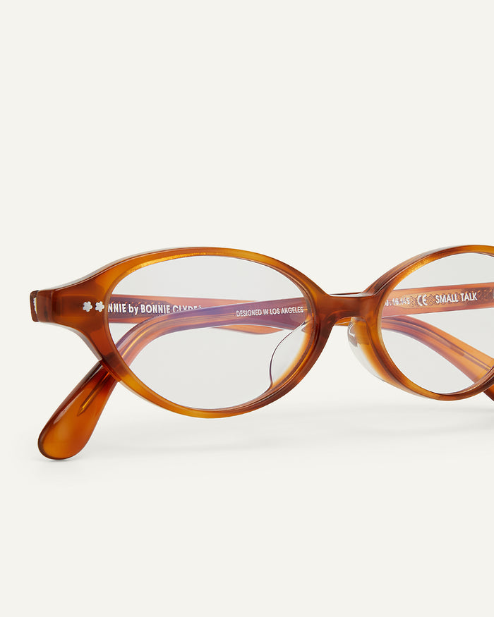Side shot of Bonnie Clyde Small Talk optical frames in yellow tortoise with clear lenses.