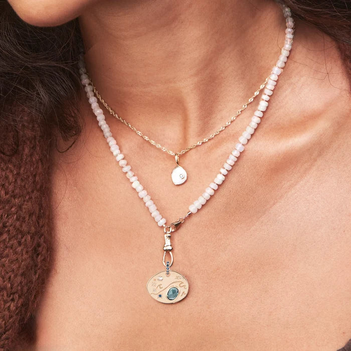 Large Water Element Necklace Charm in 10k yellow gold, shown worn on hand 2