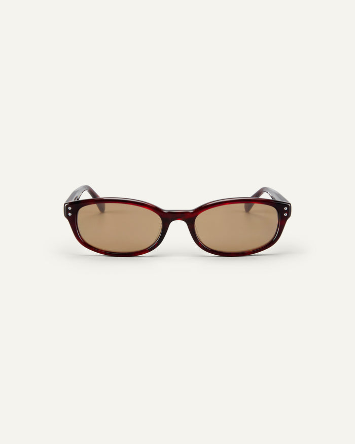 Face shot of Bonnie Clyde Sudoku sunglasses in red tortoise with brown lenses.