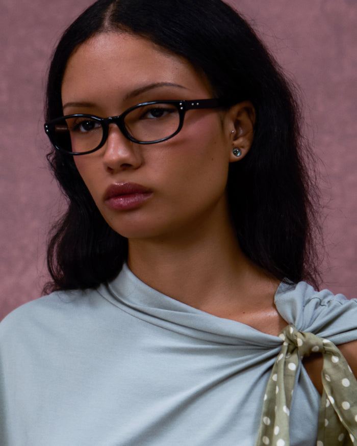 Quarter shot of Bonnie Clyde Sudoku optical frames in black with clear lenses.