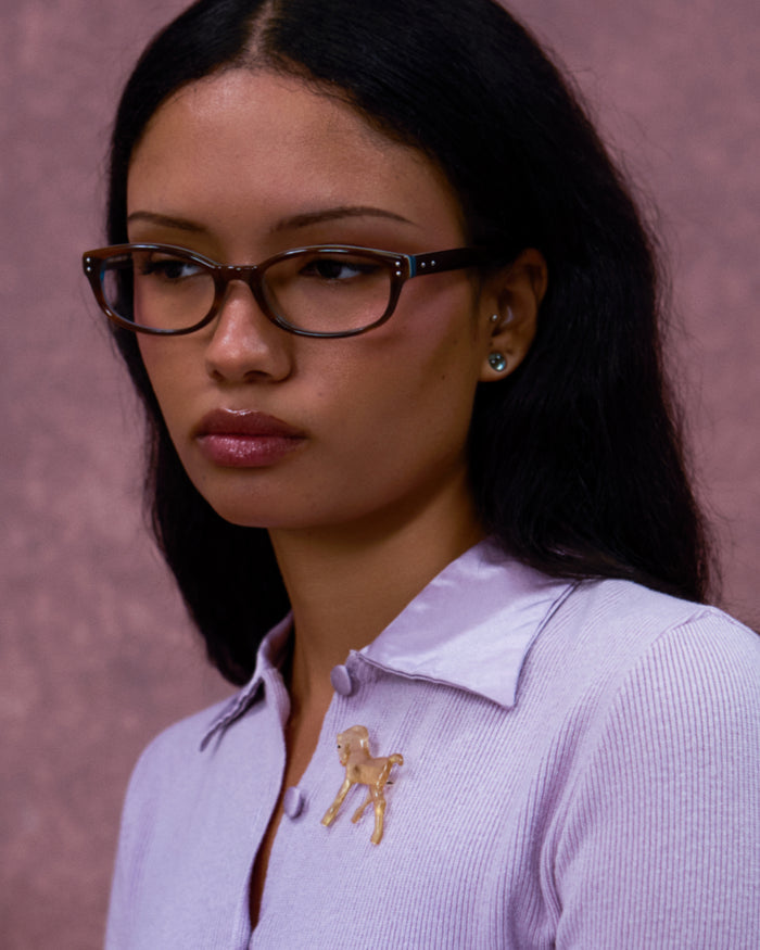 Quarter shot of Bonnie Clyde Sudoku optical frames in layered teal demi with clear lenses.