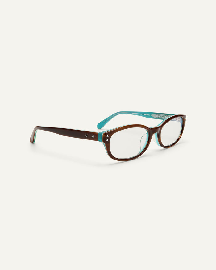 Side shot of Bonnie Clyde Sudoku optical frames in layered teal demi with clear lenses.