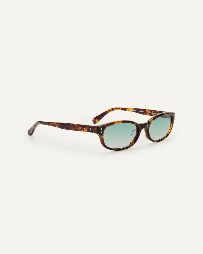Side shot of Bonnie Clyde Sudoku sunglasses in tortoise with green lenses.