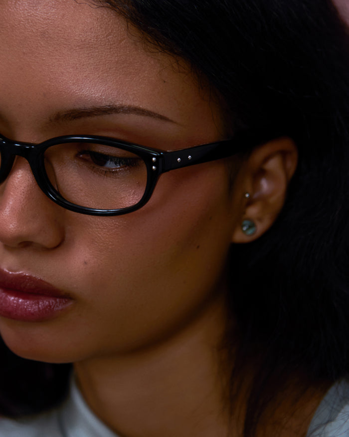 Close-up shot of Bonnie Clyde Sudoku optical frames in black with clear lenses.