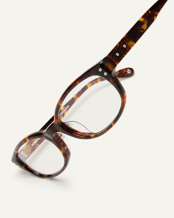 Detail shot of Bonnie Clyde Sudoku optical frames in tortoise with clear lenses.