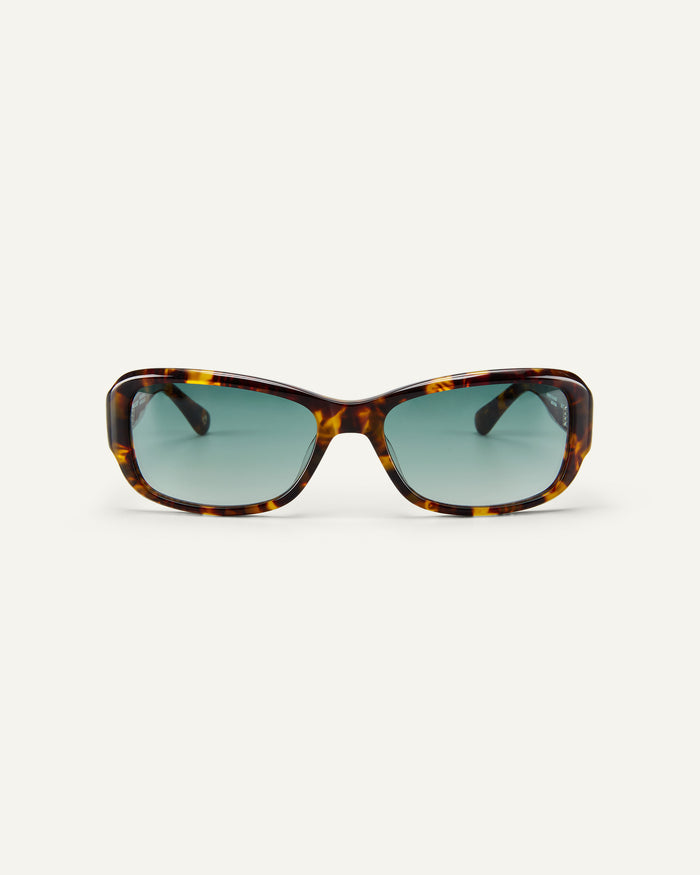 Face shot of Bonnie Clyde Sugar sunglasses in tortoise with green lenses.