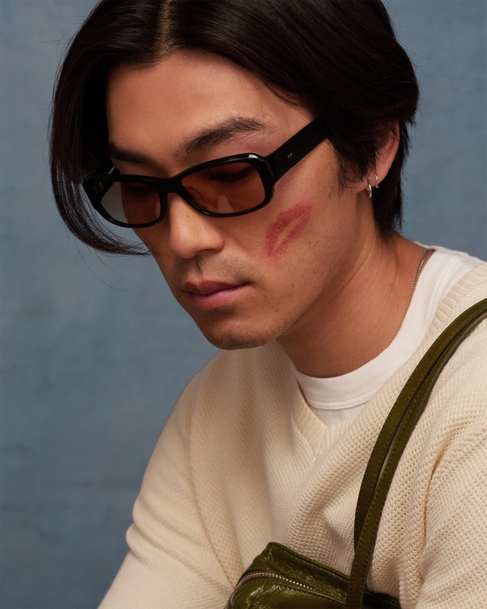 Quarter shot of Bonnie Clyde Sugar sunglasses in black with brown lenses.