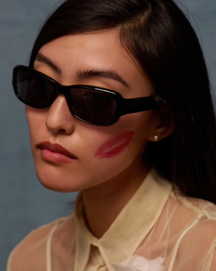 Quarter shot of Bonnie Clyde Sugar sunglasses in black with black lenses.