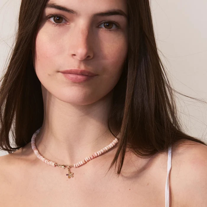 Sunset Forget-me-not Pink Flower Charm in 10k yellow gold, shown worn on hand