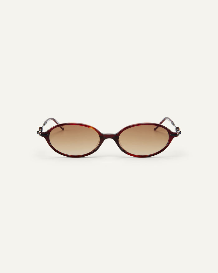 Face shot of Bonnie Clyde Swimming sunglasses in black and red tortoise with brown gradient lenses.
