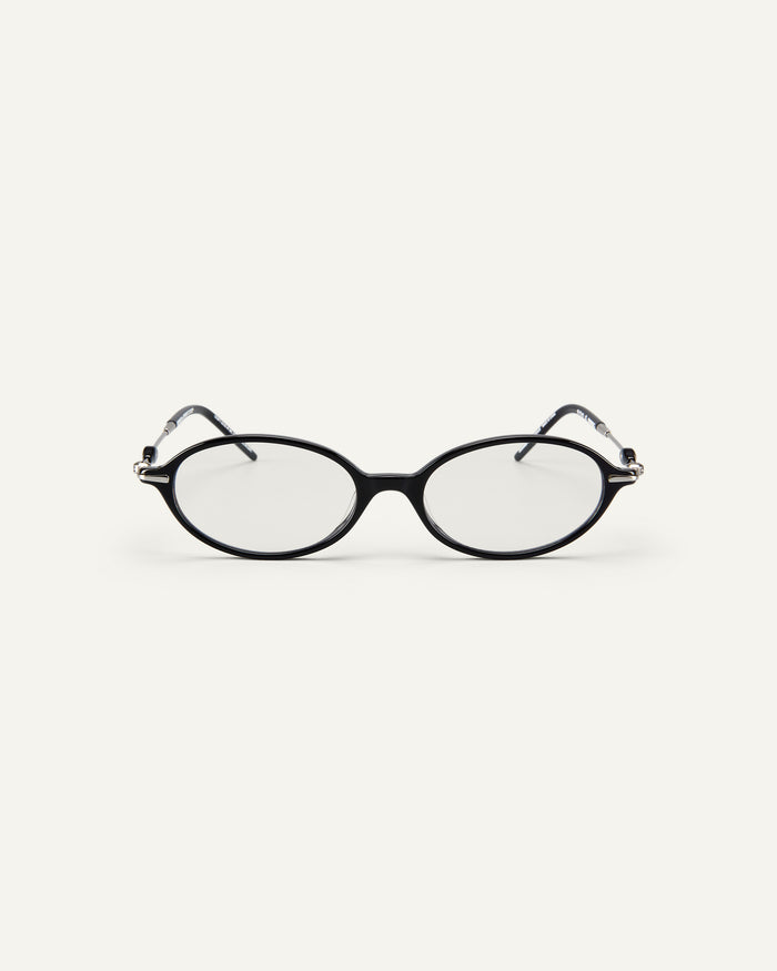 Face shot of Bonnie Clyde Swimming optical frames in silver and black with clear lenses.