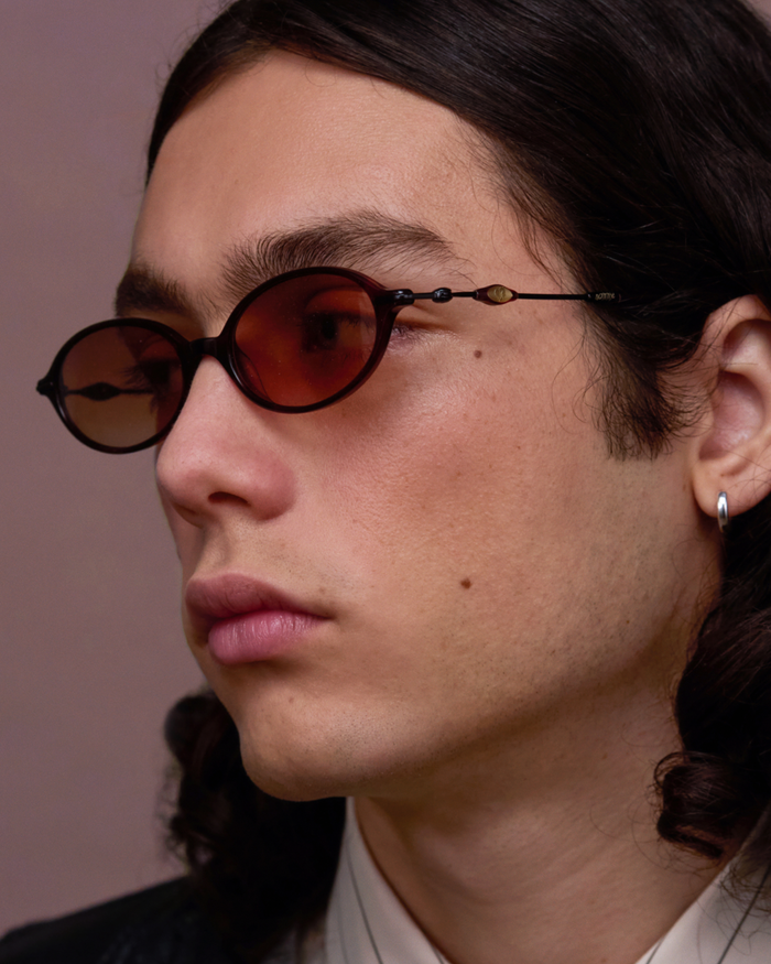 Quarter shot of Bonnie Clyde Swimming sunglasses in black and red tortoise with brown gradient lenses.