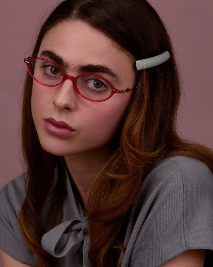 Quarter shot of Bonnie Clyde Swimming optical frames in silver and layered red with clear lenses.