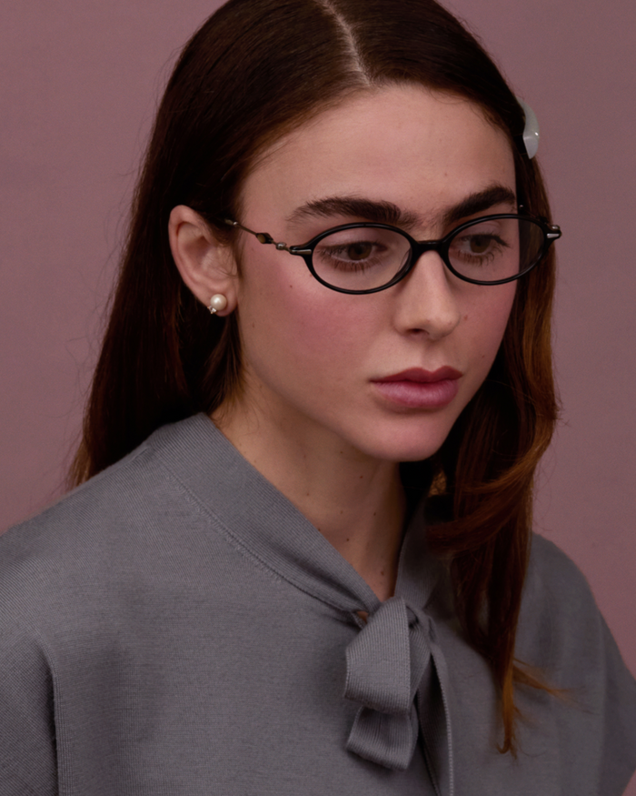 Quarter shot of Bonnie Clyde Swimming optical frames in silver and black with clear lenses.