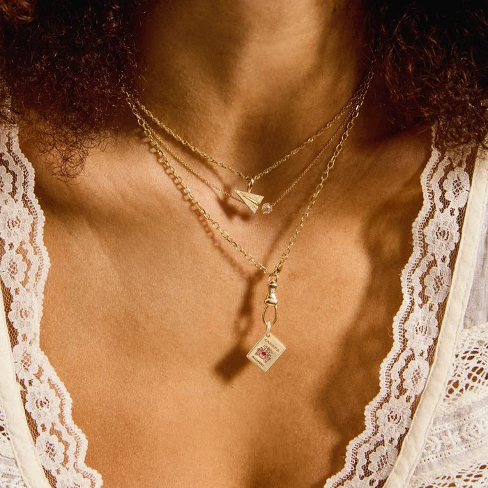 Take Flight Paper Plane Charm in 10k yellow gold with brilliant diamond, shown worn on hand 2