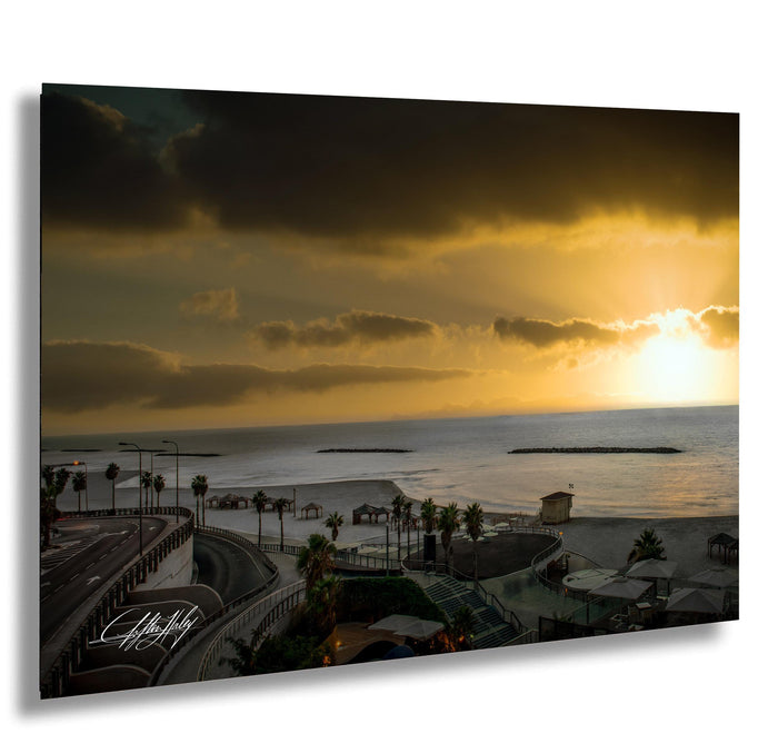 a serene beach scene at sunset, with palm trees lining the shore and a large body of water in the background.