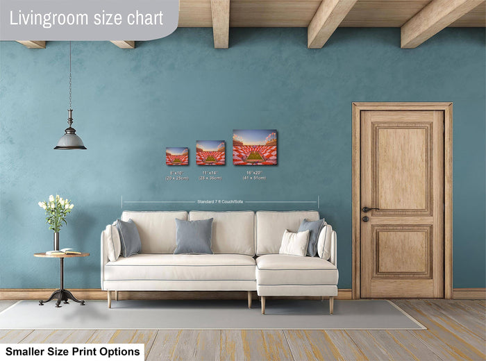 a living room with a white sofa, a wooden door, and a potted plant. There are three framed pictures hanging on the wall, and the text indicates that the living room is designed for smaller size print options.