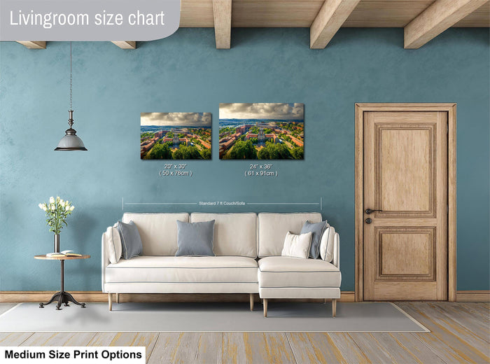 a living room with a white sofa, a wooden door, and a painting of a landscape on the wall. The painting is of a scenic view of a town or city. The living room appears to be well-decorated and spacious.