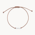 The Abacus Pearl Contemplation Cord Bracelet with taupe cord
