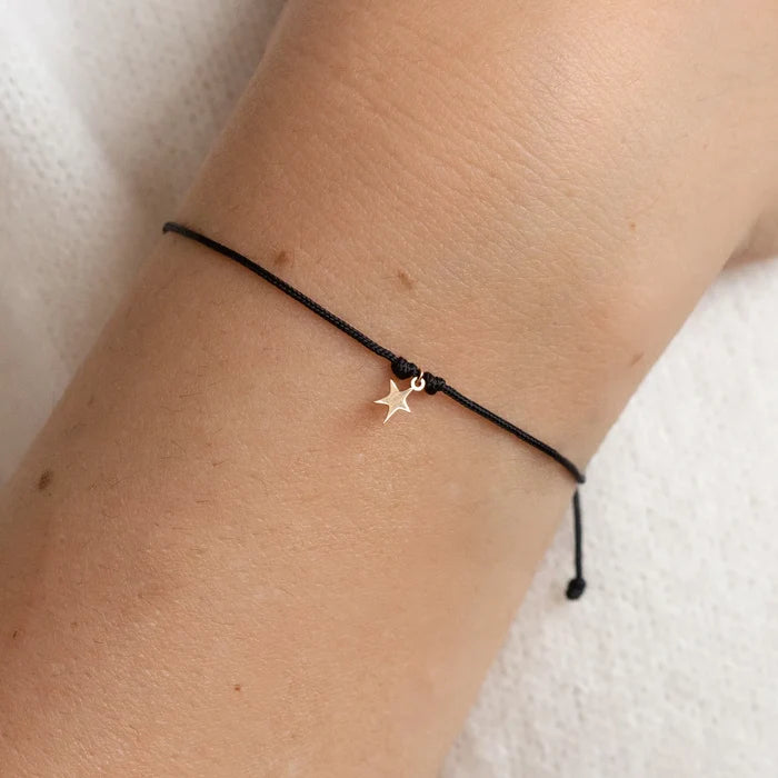 The Bright Star Contemplation Cord Bracelet in 10k yellow gold with black cord, alternate angle detail view