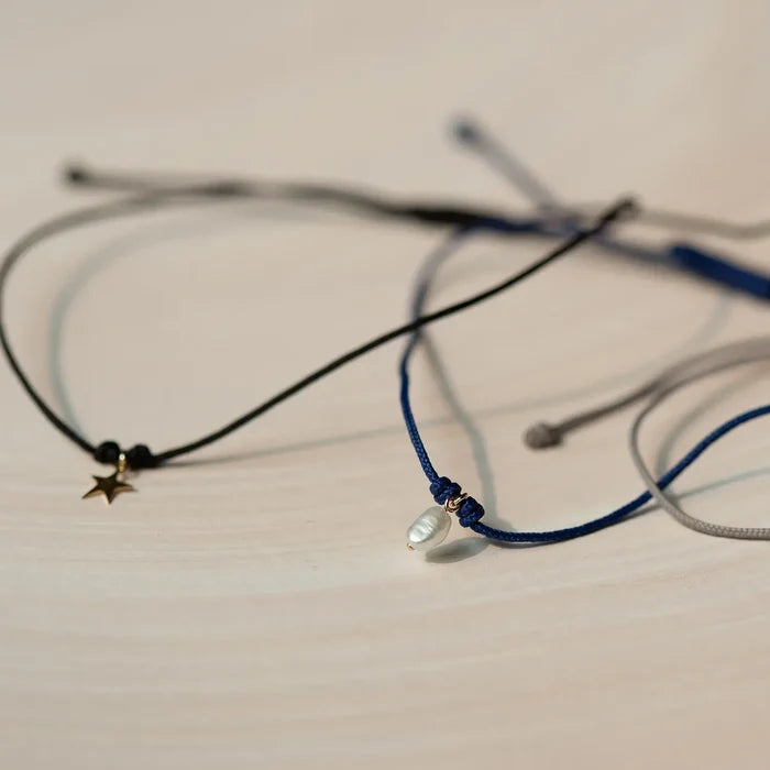 The Bright Star Contemplation Cord Bracelet in 10k yellow gold with black cord, alternate angle detail view 4
