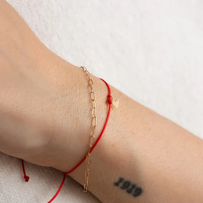 The Deep Love Contemplation Cord Bracelet in 10k yellow gold with red cord, alternate angle detail view