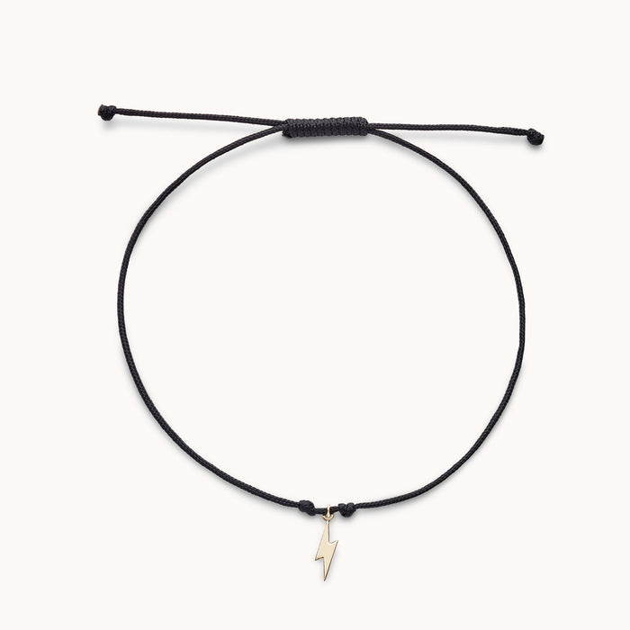 The Lightning Bolt Contemplation Cord Bracelet in 10k yellow gold with black cord